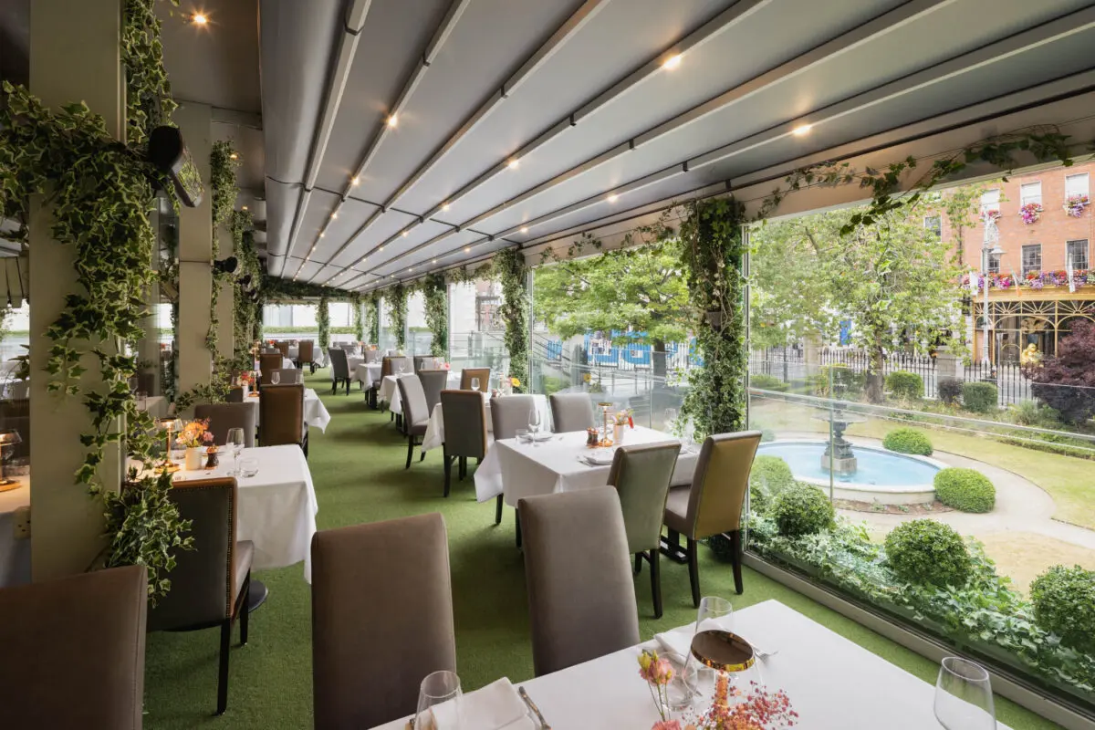 FIRE Steakhouse & Bar's all-weather terrace dining space featuring elegant vibrant greenery, overlooking The Lord Mayor's garden and Dawson Street, Dublin 2.