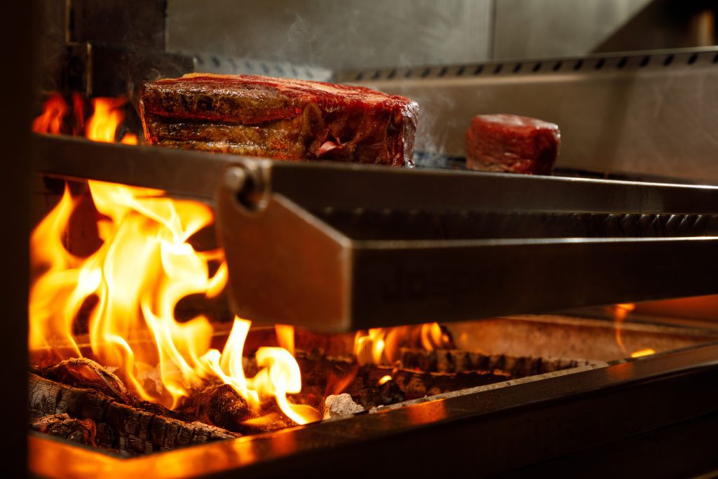 Steak cooking over the grill